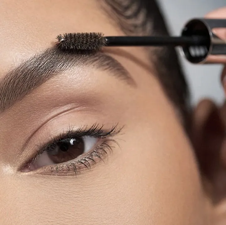 Applying brow tint with a spoolie brush at Brooklyn Brows NYC on 86th Street in Bay Ridge