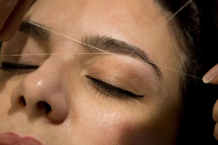Precise eyebrow threading hair removal for smooth brow maintenance