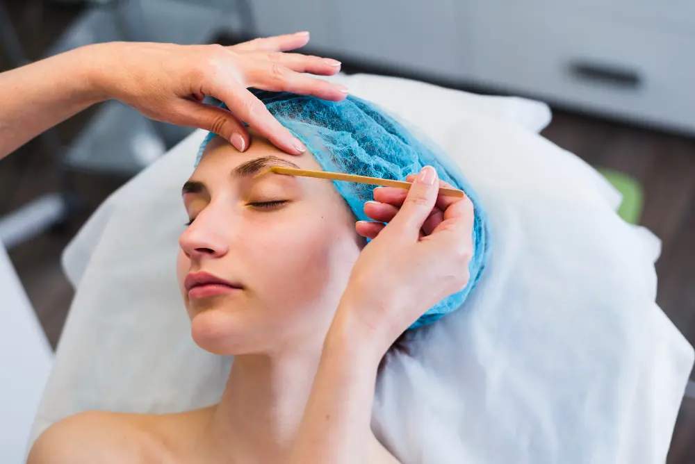 Close-up of eyebrow threading and waxing techniques, illustrating key differences in grooming methods